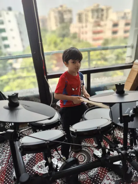 A young learner practising an electronic drum kit at DSM Dwarka Sector 22