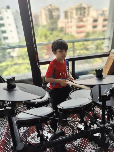 A young learner practising an electronic drum kit at DSM Dwarka Sector 22